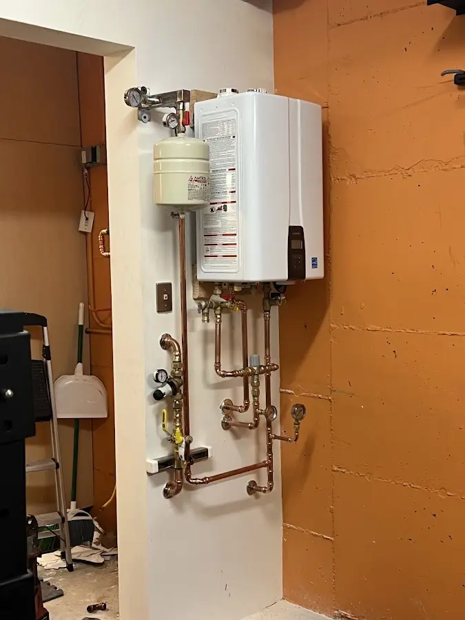 Plumbing technician inspecting water heater connections in Hawaiian Gardens